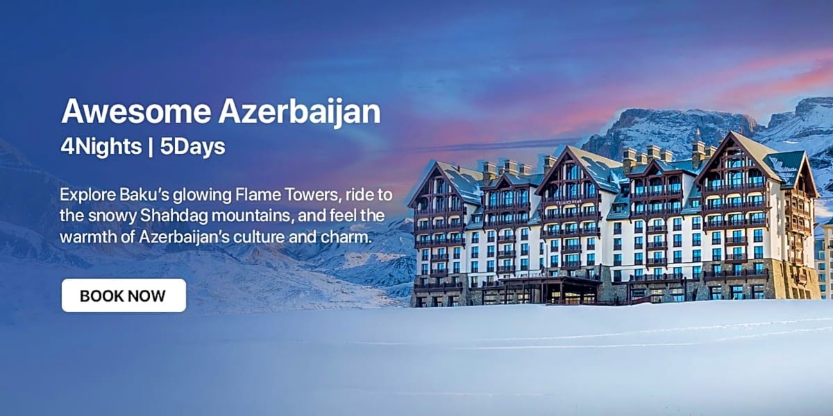 Luxury resort hotel nestled in snowy Shahdag mountains at sunset with Baku skyline in background