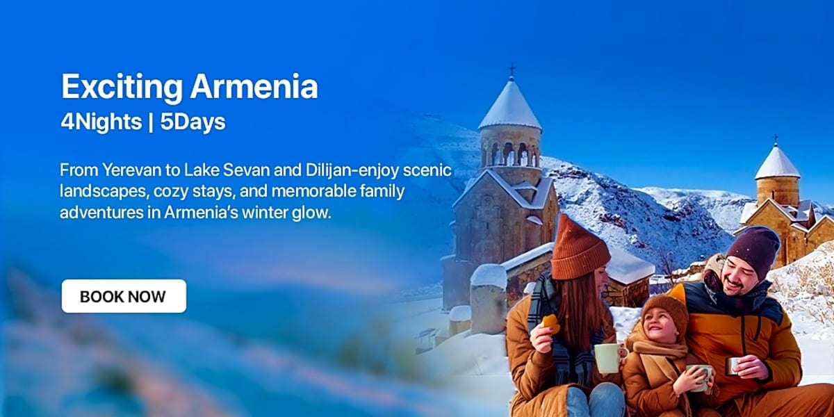Family enjoying hot drinks in front of snow-covered Armenian church with mountain landscape in winter