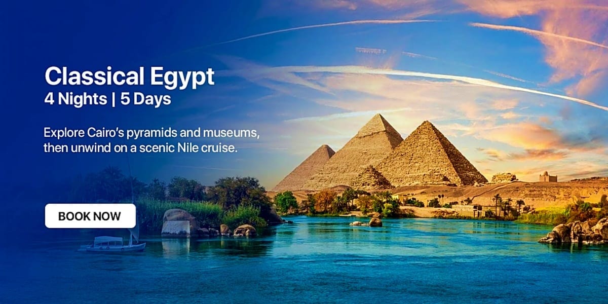 Egyptian pyramids overlooking the Nile River with a traditional felucca boat and palm trees at sunset
