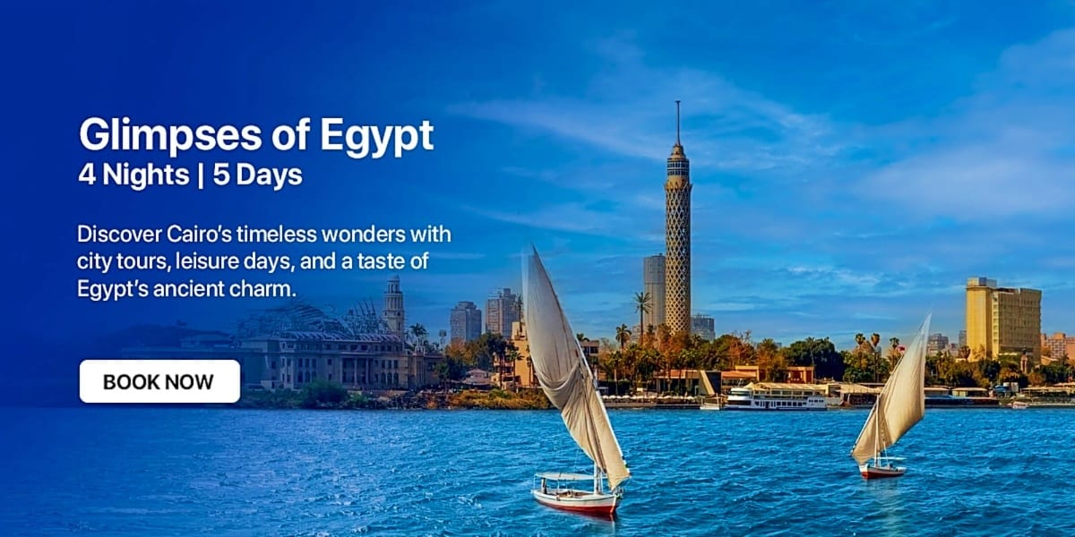 Traditional sailboats on the Nile River with Cairo cityscape and Cairo Tower in the background under blue sky