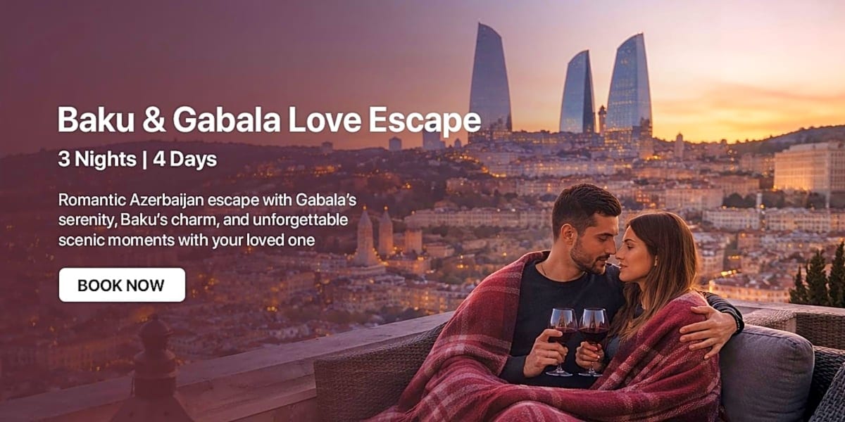 Couple toasting with wine on a balcony overlooking Baku's Flame Towers at sunset