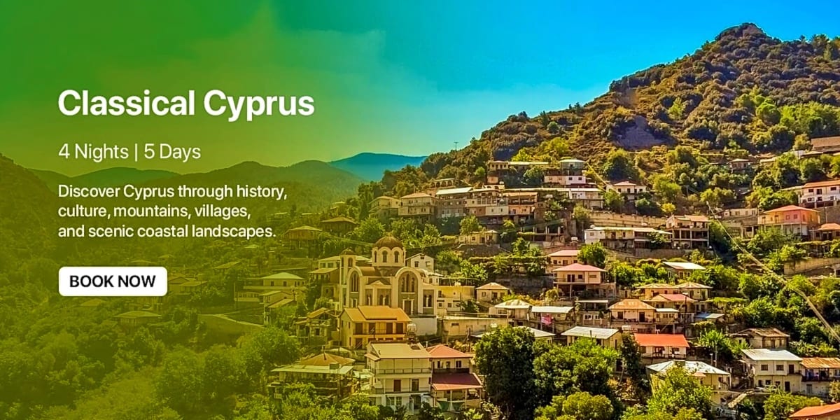 Traditional village nestled in green mountains of Cyprus with historic church and Mediterranean architecture under blue sky