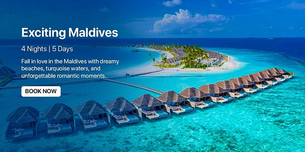 Maldives resort with overwater bungalows and turquoise lagoon with palm tree island in background