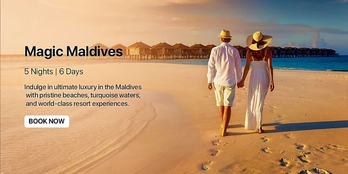 Couple walking on beach holding hands with overwater bungalows in background, Maldives