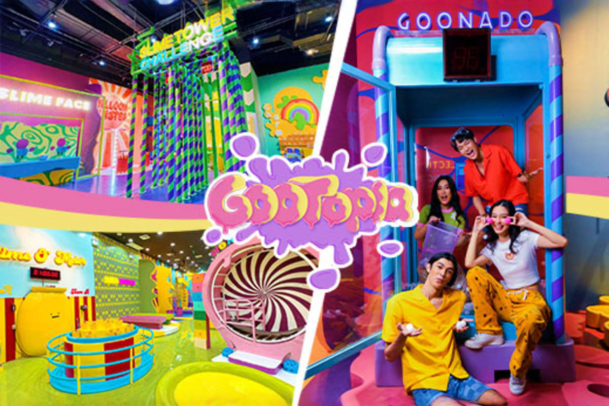 Colorful Gootopia interactive play area at SM North with vibrant neon signs, spinning ride, and visitors posing inside themed