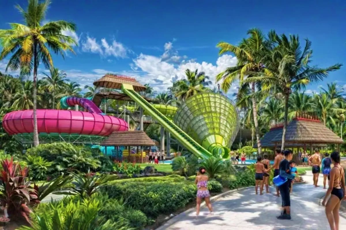 Tropical water park with colorful slides, palm trees, and visitors enjoying water attractions at Sun World Vung Tau