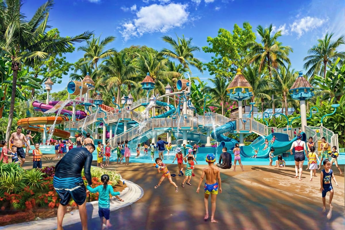 Colorful water park with multi-level castle-themed playgrounds, water slides, palm trees, and families enjoying pools and att