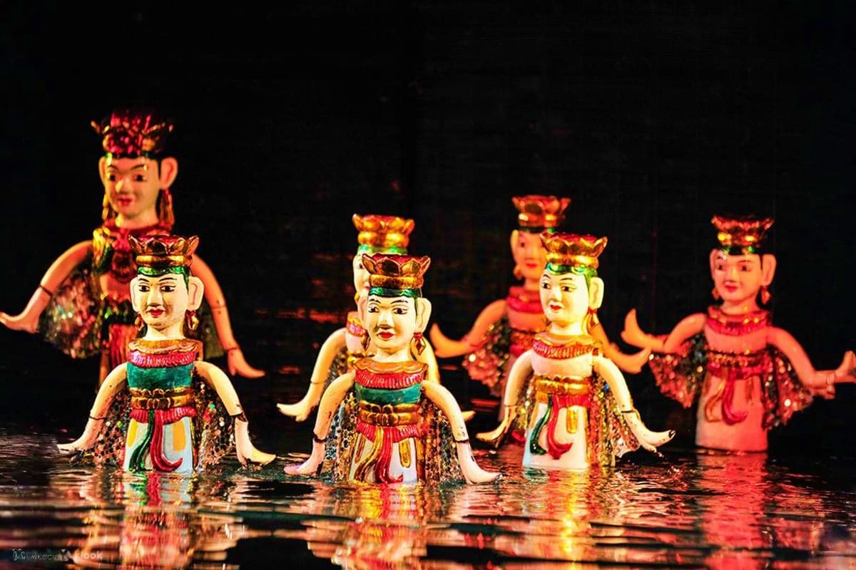 Water Puppetry Show and Dinner On Cruise Traditional Vietnamese water puppets in colorful costume performing on water stage during puppet theater show