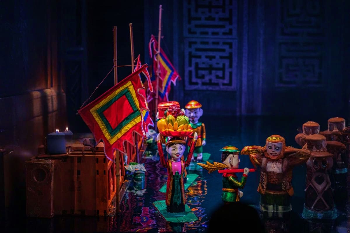 Water Puppetry Show and Dinner On Cruise Traditional Vietnamese water puppet theater performance with colorful illuminated puppets and ornate lantern-style props on s