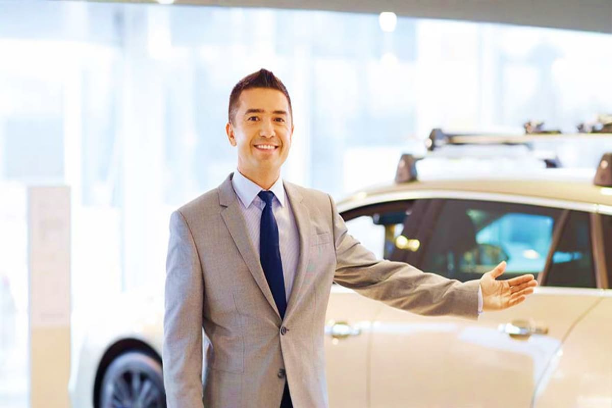 Professional man in business suit standing next to vehicle in modern airport terminal with city skyline view