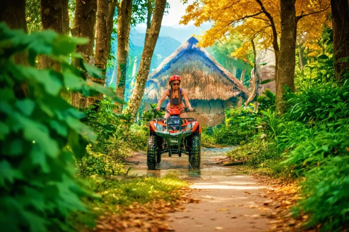 Bali ATV Tour Woman riding red ATV on forest trail with mountain and lake view in background during Bali adventure tour