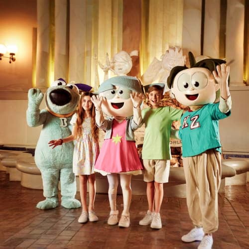 Children posing with costumed characters in KidZania indoor theme park at Dubai Mall