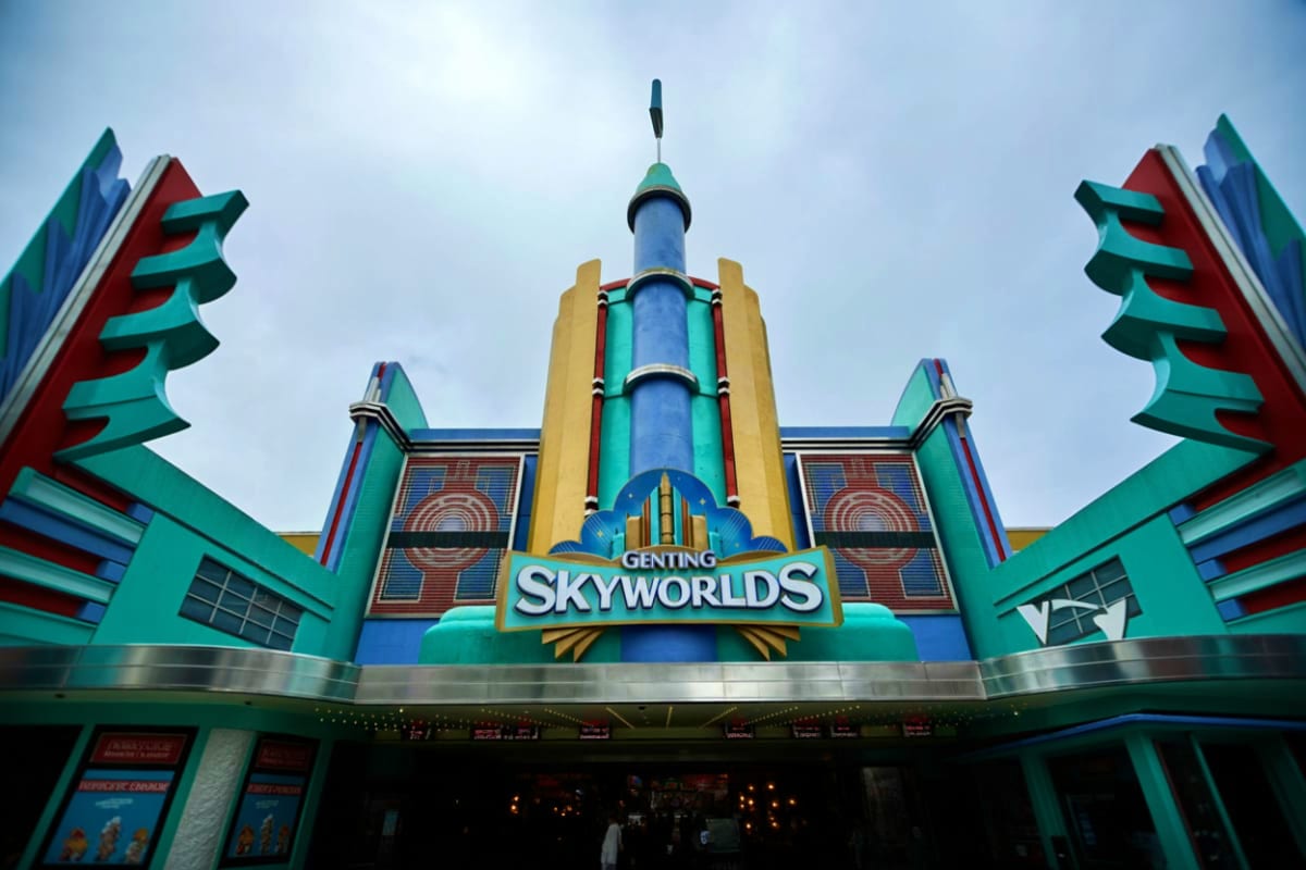 Genting Skyworlds theme park entrance with colorful art deco architecture featuring turquoise, red and blue geometric pattern