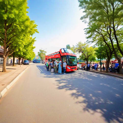 Red double-decker hop-on hop-off tour bus stopped on tree-lined street with passengers boarding, bright sunny day