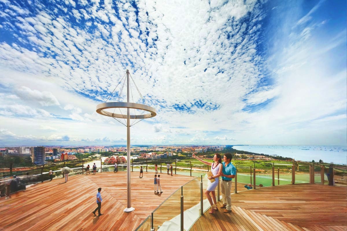 Elevated wooden deck with metal circular canopy structure overlooking coastal city, bay, and distant coastline under blue sky