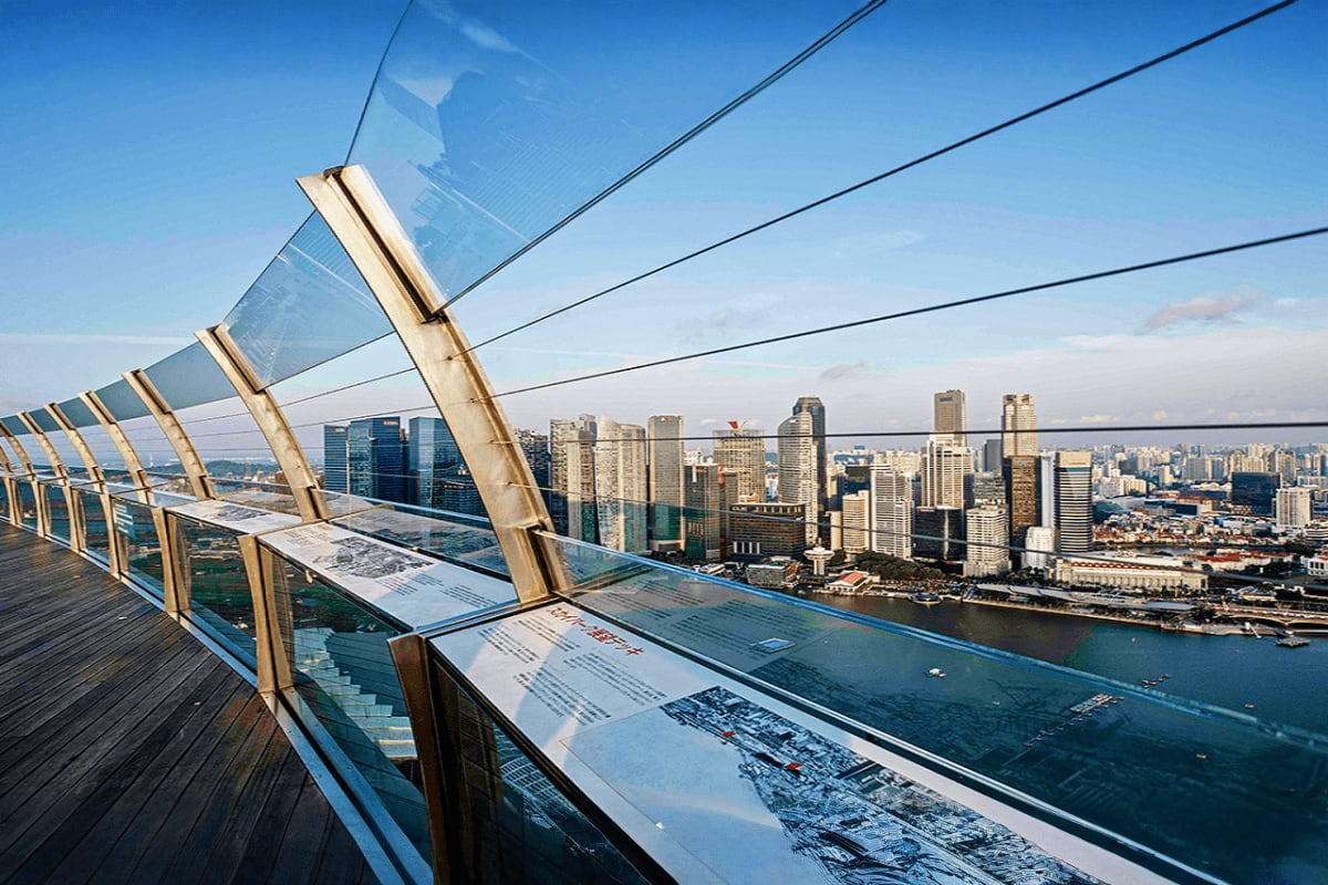 Marina Bay Sands Sky Park View of San Francisco skyline and bay from Marina Bay Sands observation deck with glass railings and informational plaques