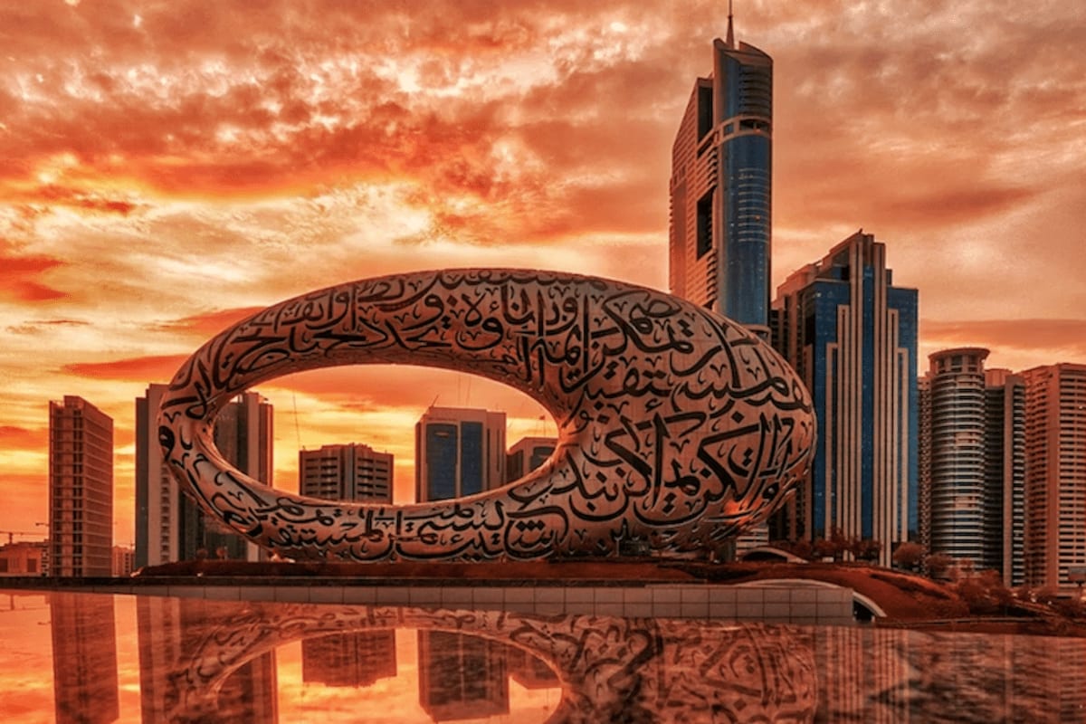 Museum of the Future Museum of the Future sculpture with Arabic calligraphy arch over reflecting pool, Dubai skyline at sunset