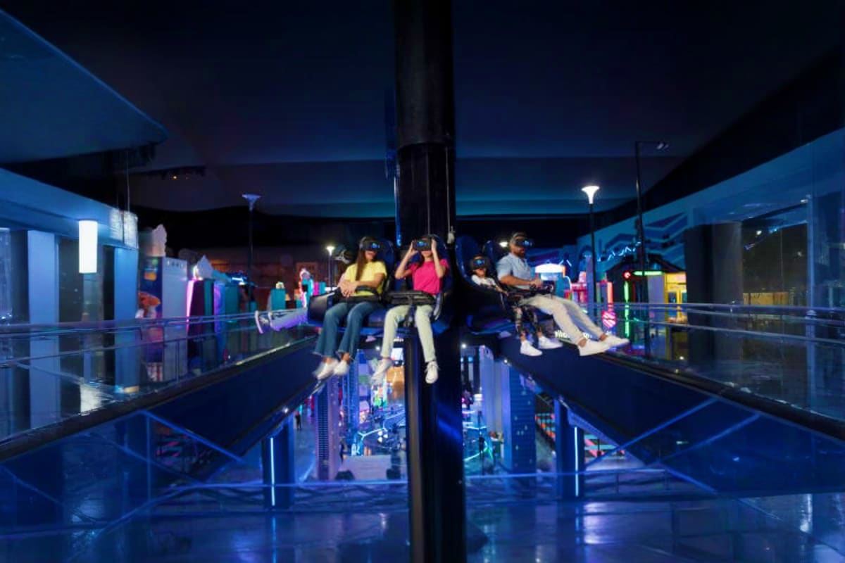 Play DXB Dubai People enjoying virtual reality and gaming attractions at an indoor entertainment venue in Dubai at night