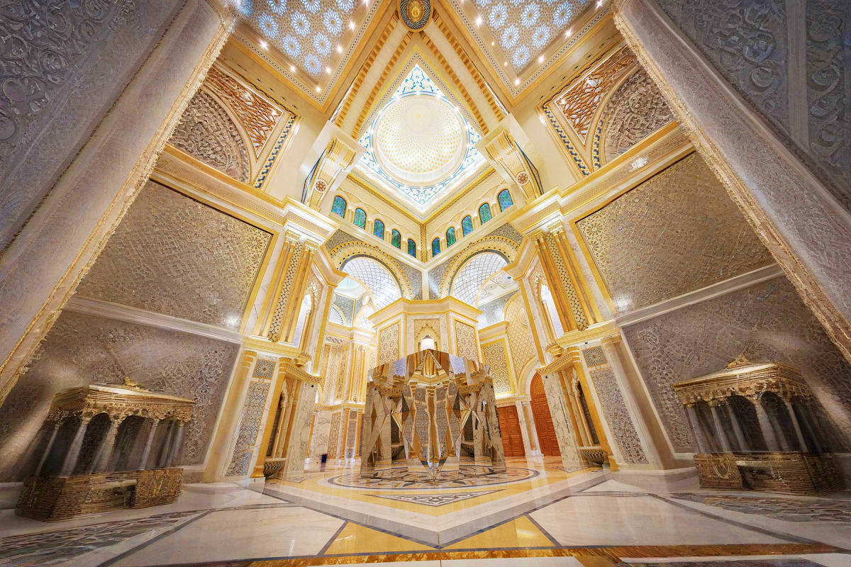 Qasr Al Watan Abu Dhabi Ornate interior of Qasr Al Watan palace with symmetrical gold-trimmed architecture, intricate geometric wall patterns, centra