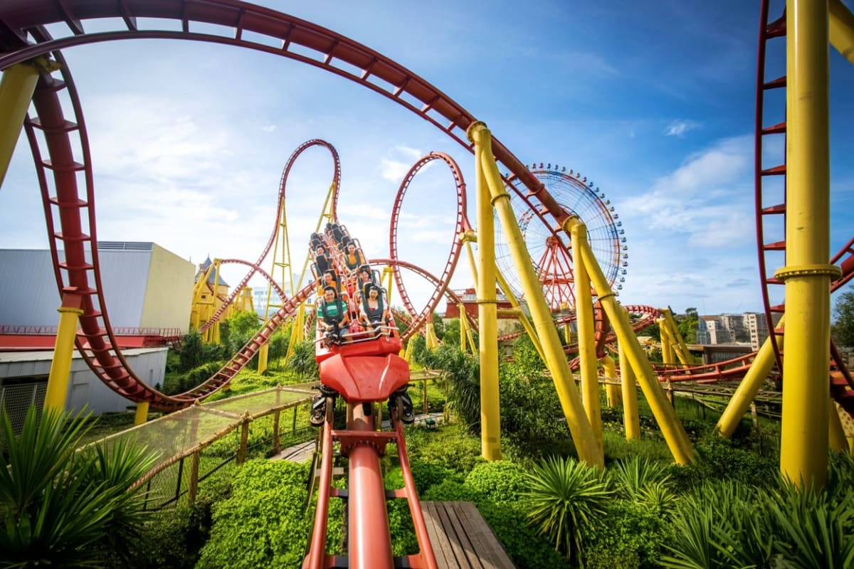VinWonders Grand Park Ho Chi Minh Red and yellow roller coaster with loop inversions at VinWonders Grand Park amusement park in Ho Chi Minh City