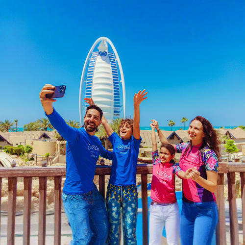 Wild Wadi Water Park Family taking selfie at Wild Wadi Water Park with Burj Al Arab hotel in background, Dubai