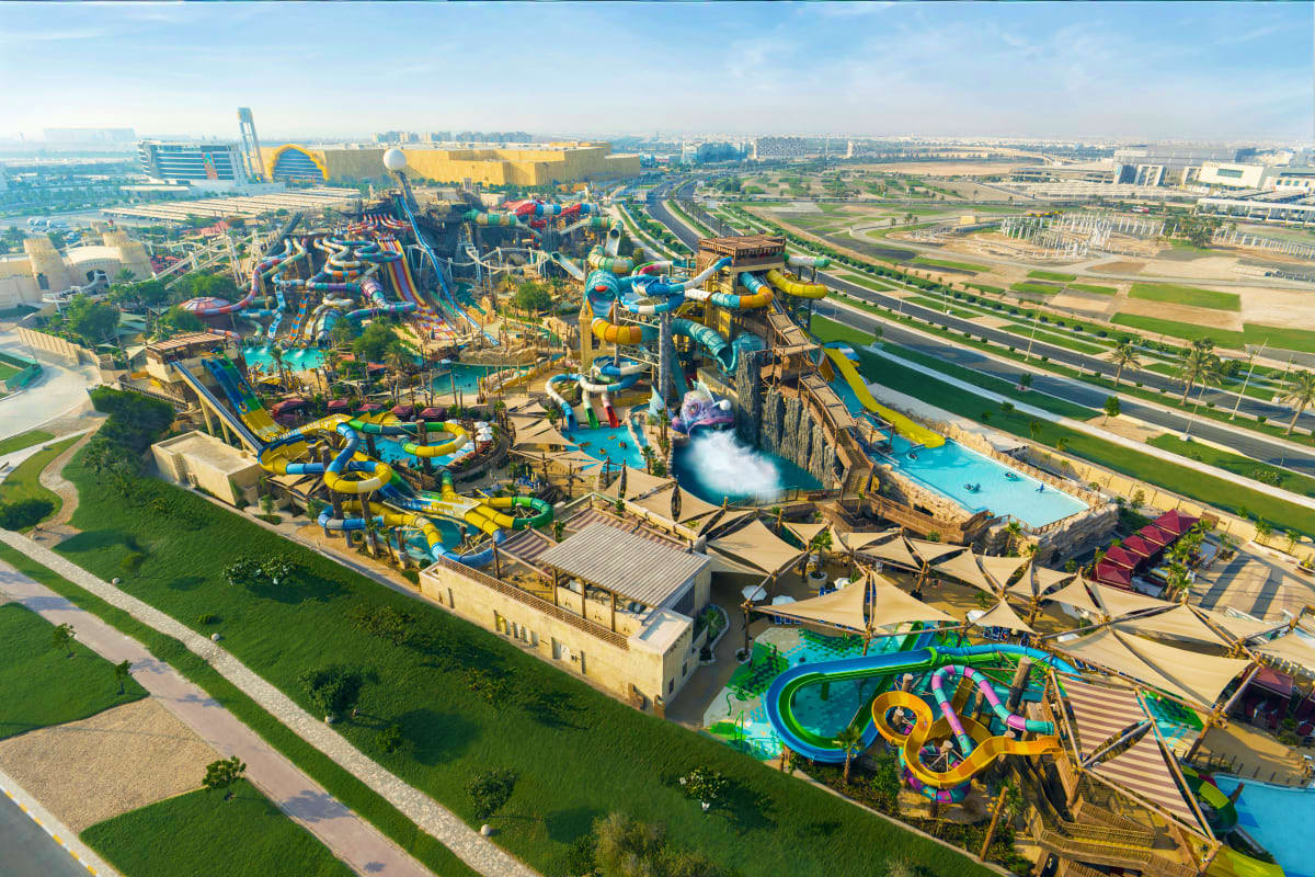 Yas Waterworld Aerial view of Yas Waterworld theme park with colorful water slides, pools, and attractions surrounded by desert landscape an