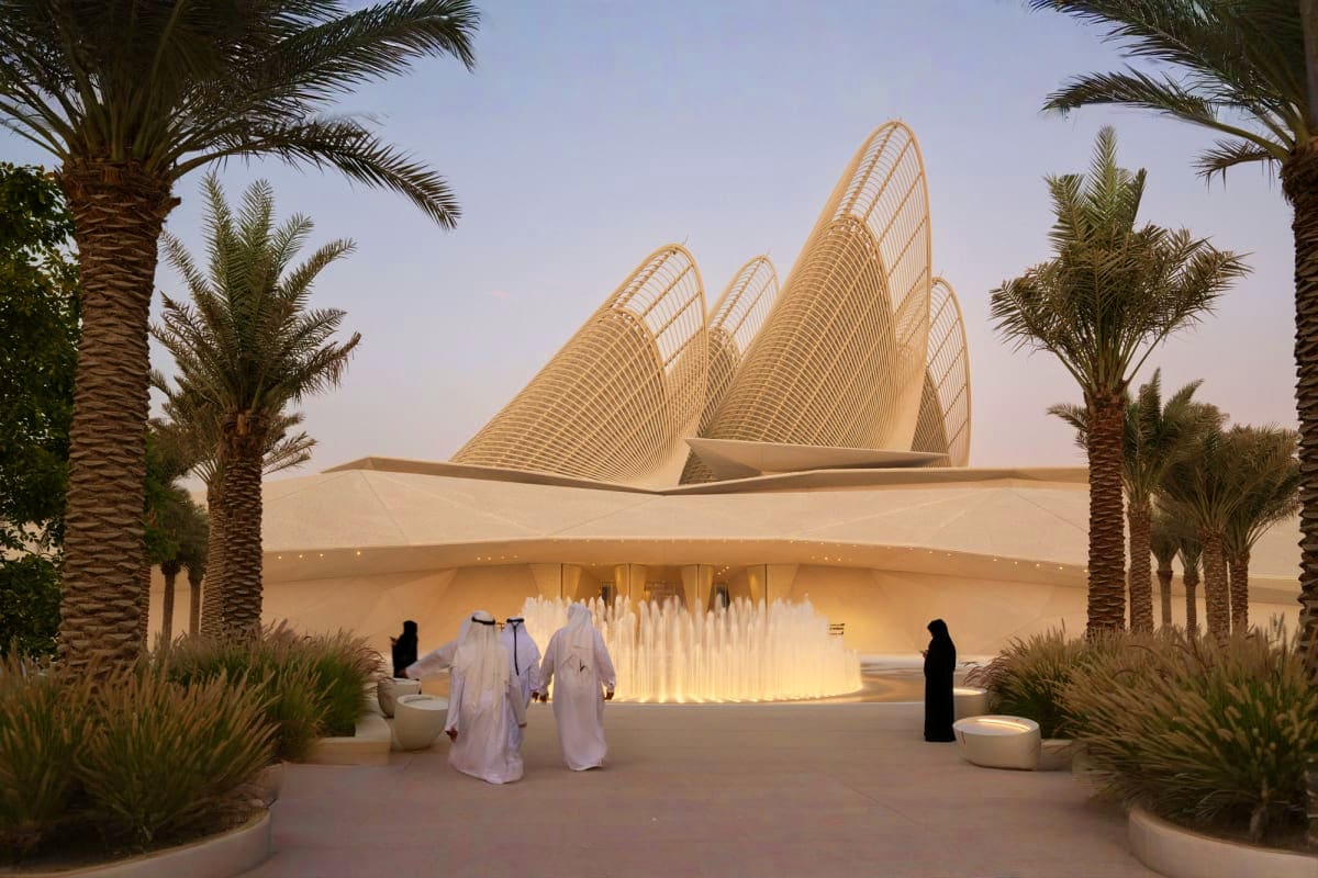 Zayed National Museum Modern architectural exterior of Zayed National Museum with distinctive curved white ribbed structures, surrounded by palm tr