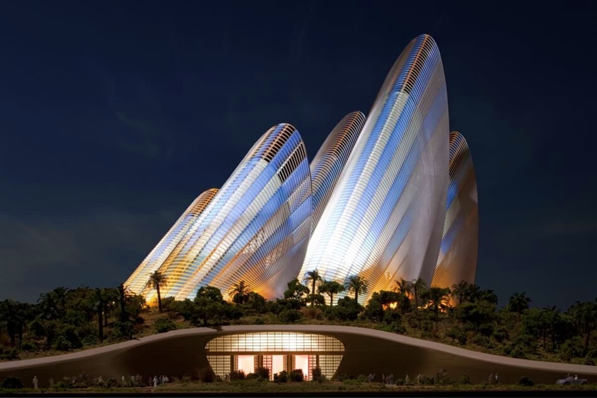Zayed National Museum Zayed National Museum illuminated at night with three sail-shaped white structures and palm trees surrounding the contemporar