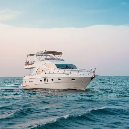 Luxury white motor yacht anchored in calm blue ocean waters during daytime