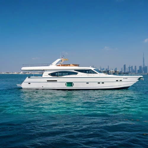 White luxury motor yacht anchored in turquoise water with Dubai skyline in background