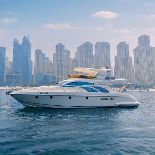 Luxury white and blue yacht moored in Dubai Marina with modern skyscrapers in background