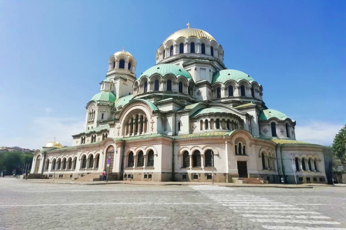 Alexander Nevsky Cathedral with white stone facade, green domes and golden crosses in Sofia, Bulgaria