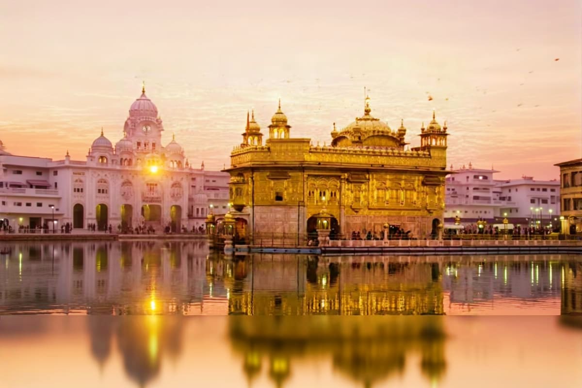 Golden Temple reflected in sacred pool at sunset in Amritsar, India