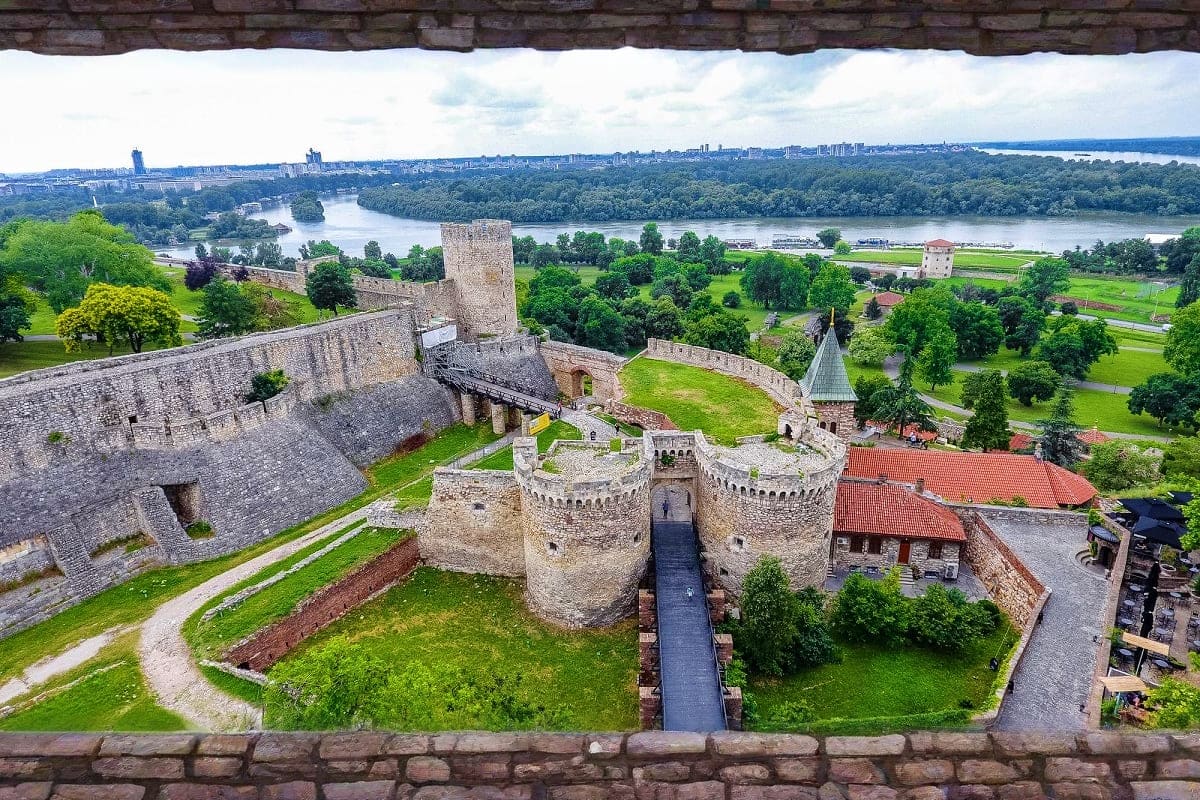 Aerial view of Kalemegdan Fortress in Belgrade with stone towers and walls overlooking the Danube River and green landscape b