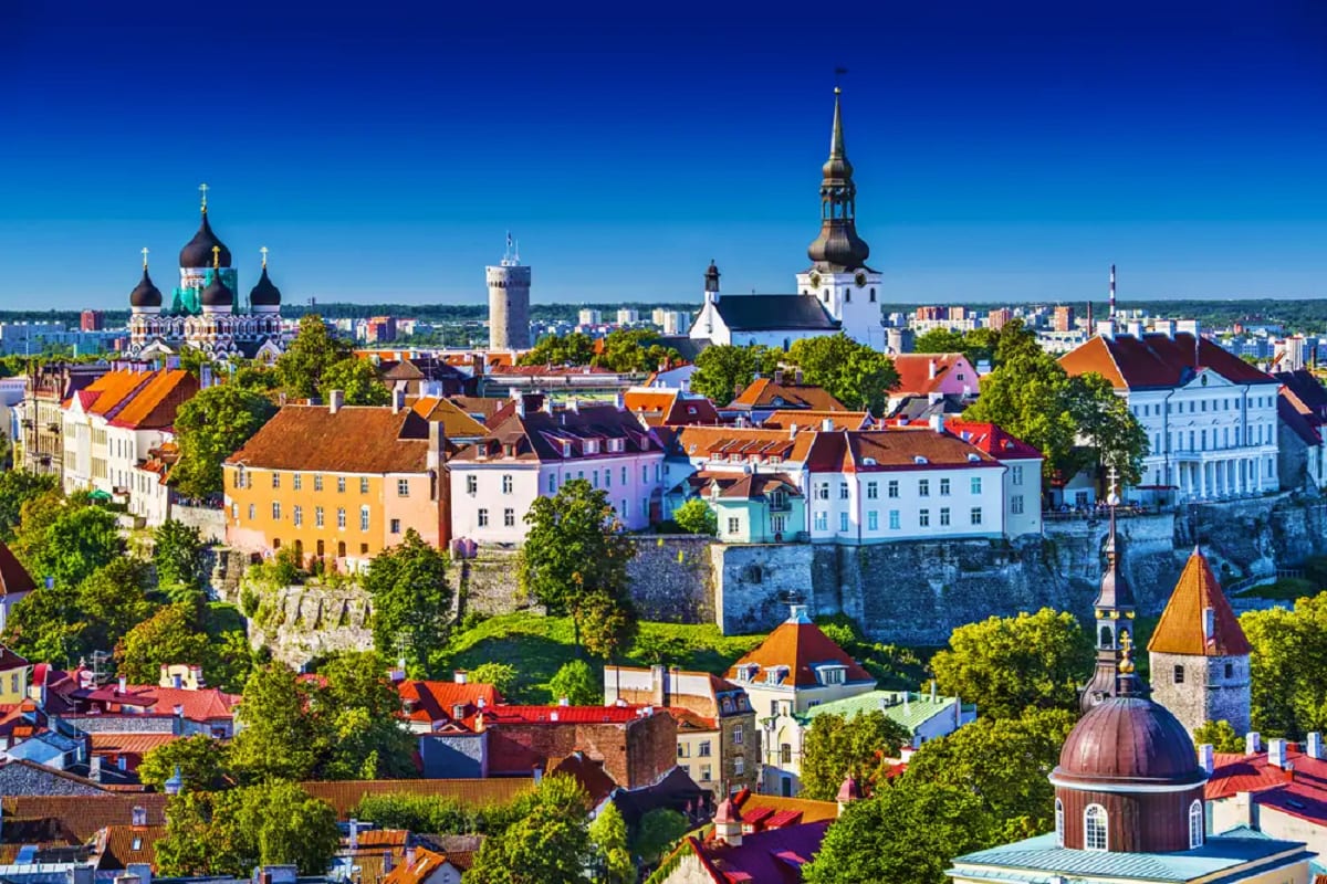 Baltic Capitals & Berlin Explorer Aerial view of Tallinn Old Town with colorful historic buildings, medieval walls, Orthodox cathedral with golden domes, and c