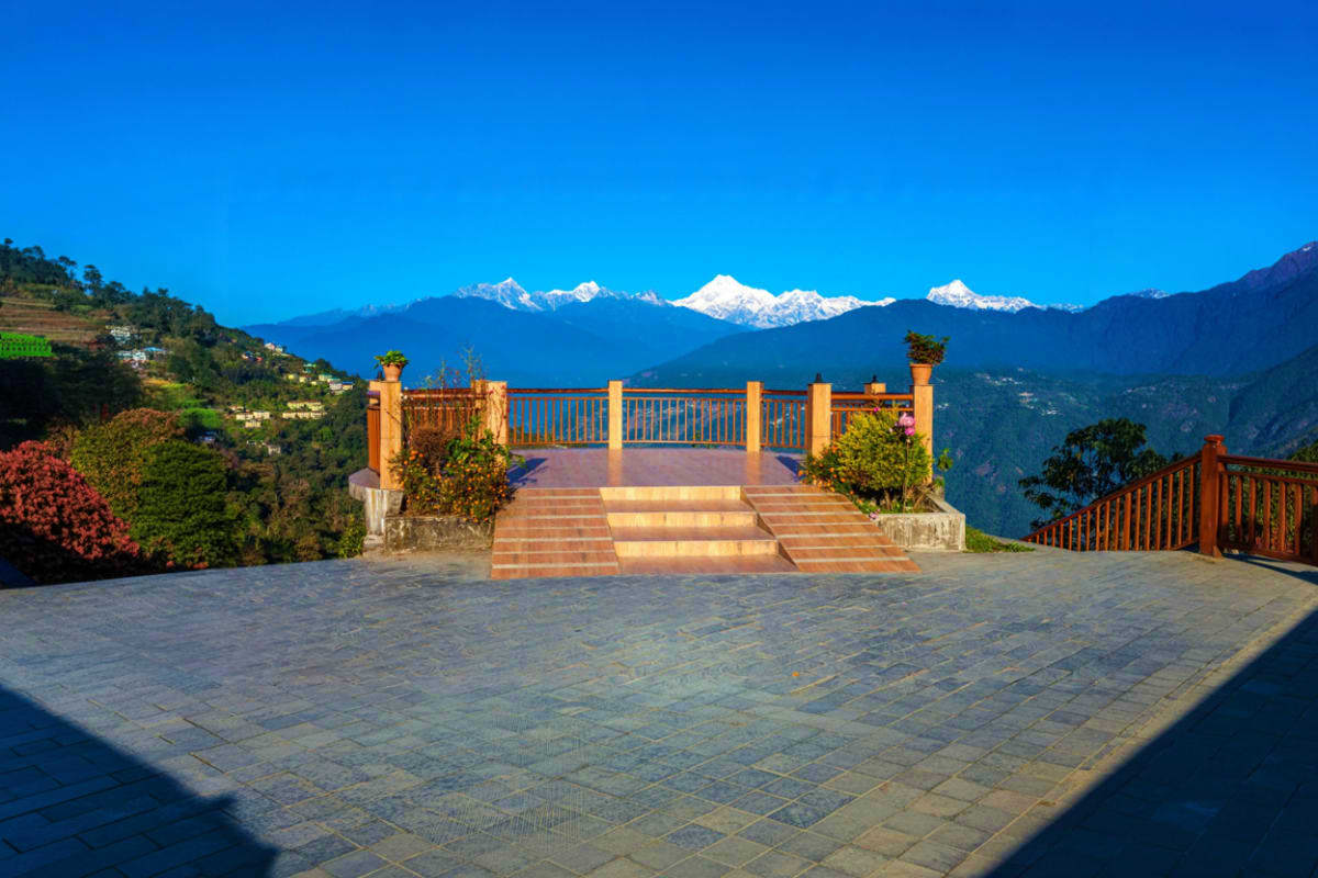 Pelling Skywalk viewing platform with snow-capped Kanchenjunga mountain range and Himalayan valley landscape in background