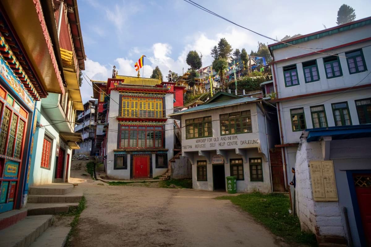 Traditional Tibetan Buddhist monastery with ornate red and gold architecture in Darjeeling, Sikkim hillside village with pray