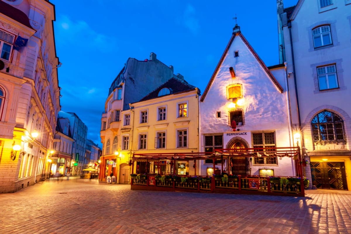 Historic Old Town square in Tallinn at twilight with illuminated medieval buildings and Peppersack restaurant