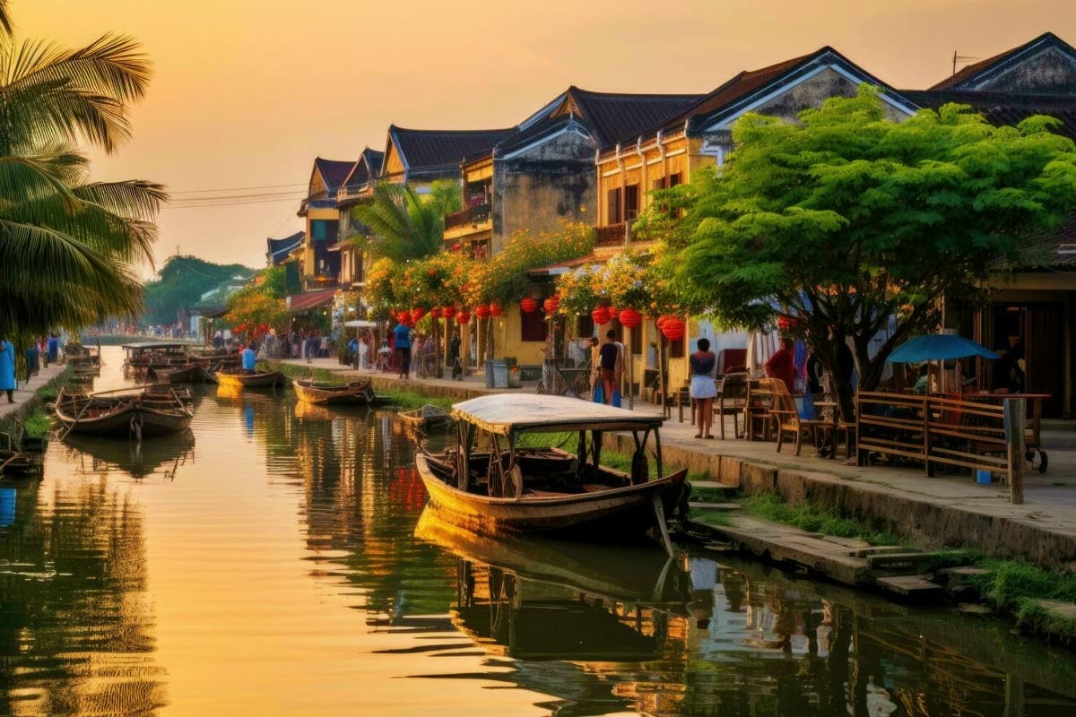 Ancient waterway town with traditional wooden boats, yellow-painted historic buildings with dark roofs, red lanterns, and pal
