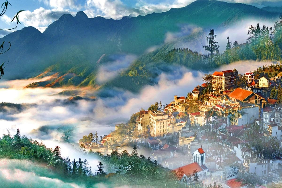Alpine village nestled in misty mountains with traditional European architecture and forested slopes