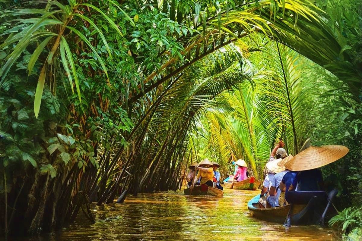 Tourists in traditional boats navigating through mangrove forest tunnel in Vietnam Mekong Delta