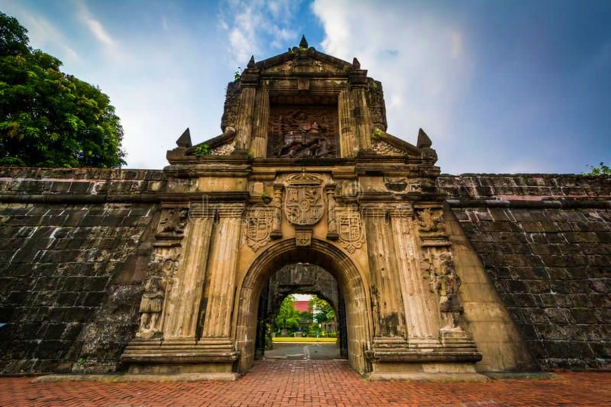 Ultimate Manila and Cebu Holiday Package Historic stone fort gate with ornate baroque architecture and arched entrance in Manila, Philippines