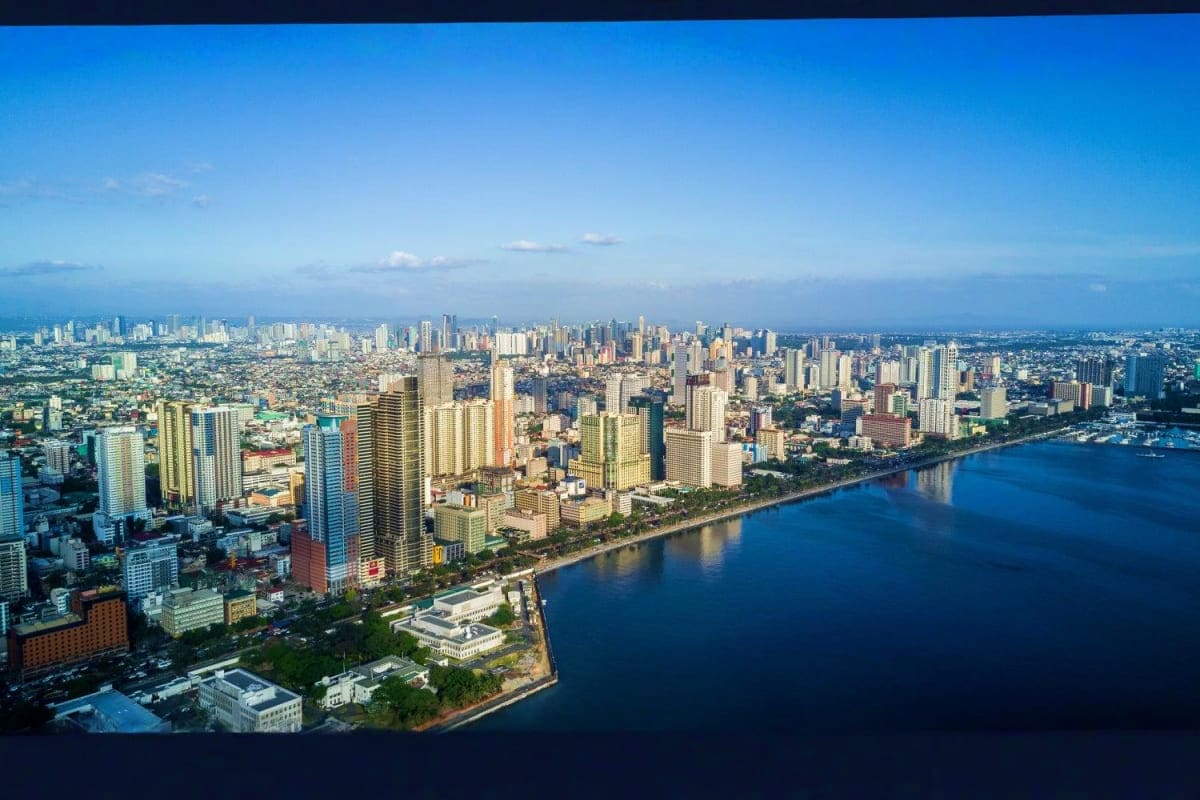 Manila Batangas Short Tour Aerial view of Honolulu coastline with high-rise hotels and buildings along Waikiki Beach and blue ocean waters
