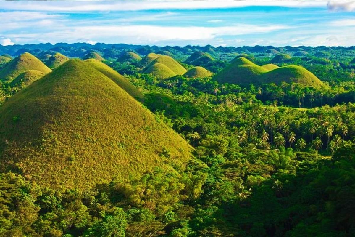 Simply Bohol Aerial view of the Chocolate Hills in Bohol, Philippines, showing hundreds of distinctive cone-shaped limestone formations co