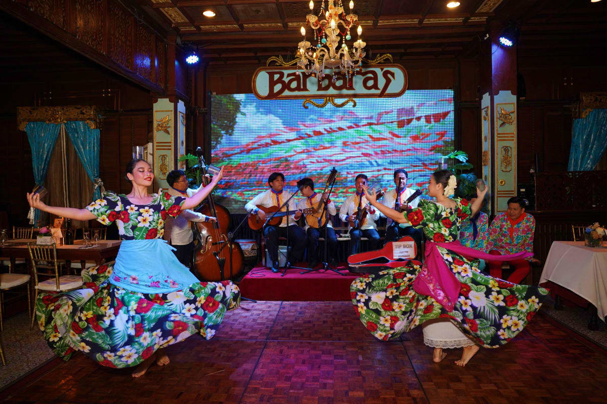 Manila Food Tour Traditional Filipino cultural performance with dancers in colorful floral costumes and musicians playing at Barbaras restaura