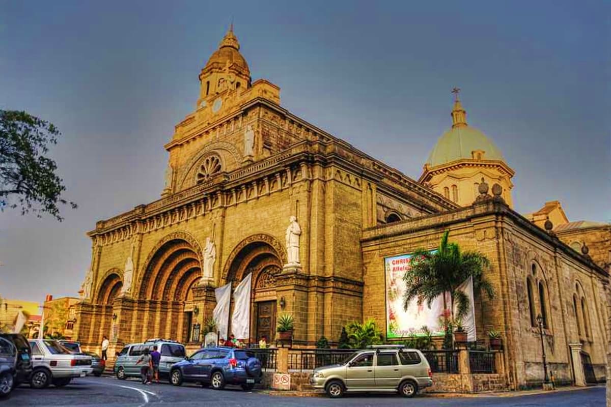 Manila Coron Escape Tour Historic Catholic cathedral with golden domes and ornate stone facade in Manila, Philippines