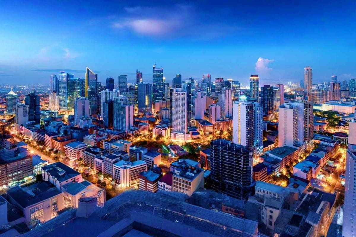 Pristine Palawan Tour Chicago skyline at dusk with illuminated skyscrapers and city lights under blue evening sky