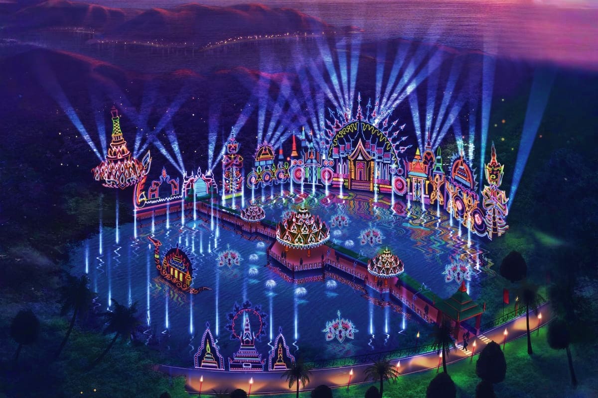 Illuminated Thai temple complex at night with elaborate neon-lit architecture, blue light beams, and traditional decorative s