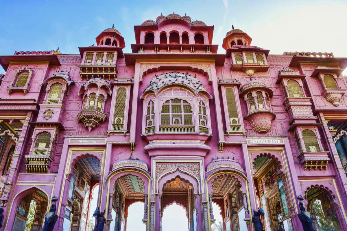 The Crown Jewels of Rajasthan Pink palace facade with ornate domes, arched doorways, and intricate architectural details in traditional Indian Rajasthani s