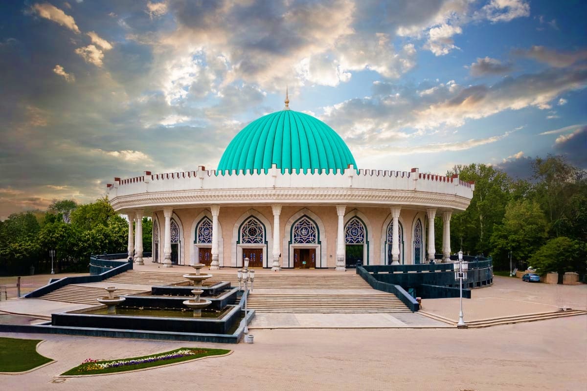 Exterior view of Hazrati Imam Complex with turquoise dome and white columns in Tashkent, Uzbekistan
